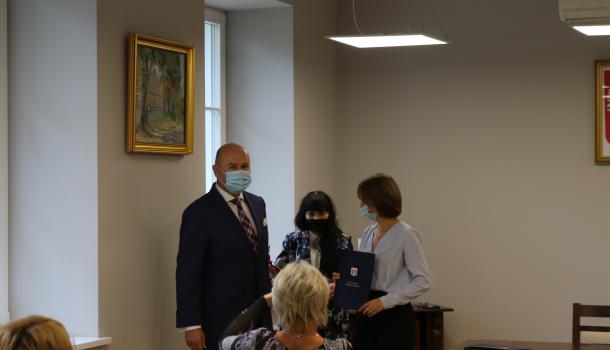 Burmistrz Sławomir Kowalewski wręcza nagrodę nauczycielowi