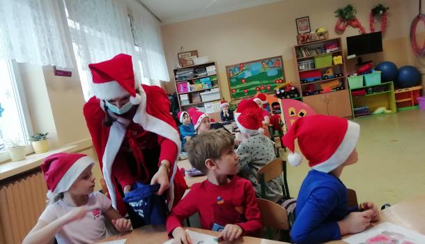 Oddziały przedszkolne przy Szkole Podstawowej Nr 6, dzieci malują mikołaja i jedzą cukierki 